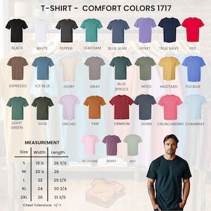 May include: A selection of Comfort Colors 1717 t-shirts in a range of colours, including black, white, and red. The image includes a size chart with measurements in inches, from small to 2XL. A man is wearing a dark green t-shirt.