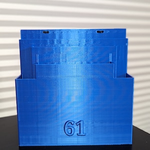 May include: A blue plastic storage box with the number 61 printed on the front.