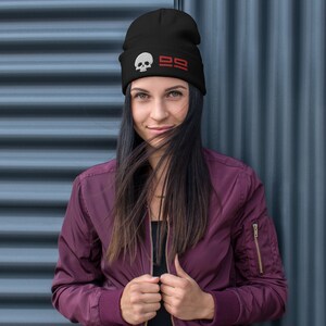 May include: A black beanie with a white skull and red "99" graphic.