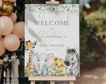 Puede incluir: Bienvenido a la fiesta de bienvenida al bebé de Harlow, con un fondo de acuarela con una jirafa, un elefante, un león y una cebra. El cartel está en un caballete de madera.