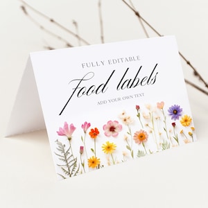 May include: White card with the text "FULLY EDITABLE food labels ADD YOUR OWN TEXT" in black script font. The card is decorated with a row of pressed flowers in shades of pink, purple, yellow, orange, and white.