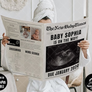May include: A black and white newspaper-style announcement with the headline "The New Baby Times". The announcement says "Baby Sophia is on the way!" and has a due date of January 2024. The announcement also includes a black and white ultrasound image.