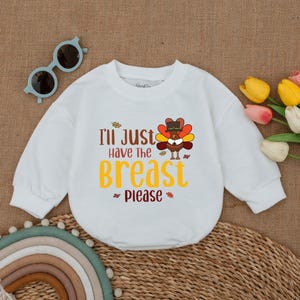 May include: White long-sleeve shirt with a Thanksgiving turkey graphic and the text "I'll just have the breast please".