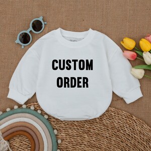 May include: White long-sleeve shirt with the text "CUSTOM ORDER" printed in black.