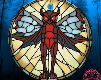 May include: A round ceramic ornament featuring a stained-glass style illustration of a red and brown moth-like creature with glowing red eyes. The design is set against a circular background of yellow and light blue geometric panels with black lines.