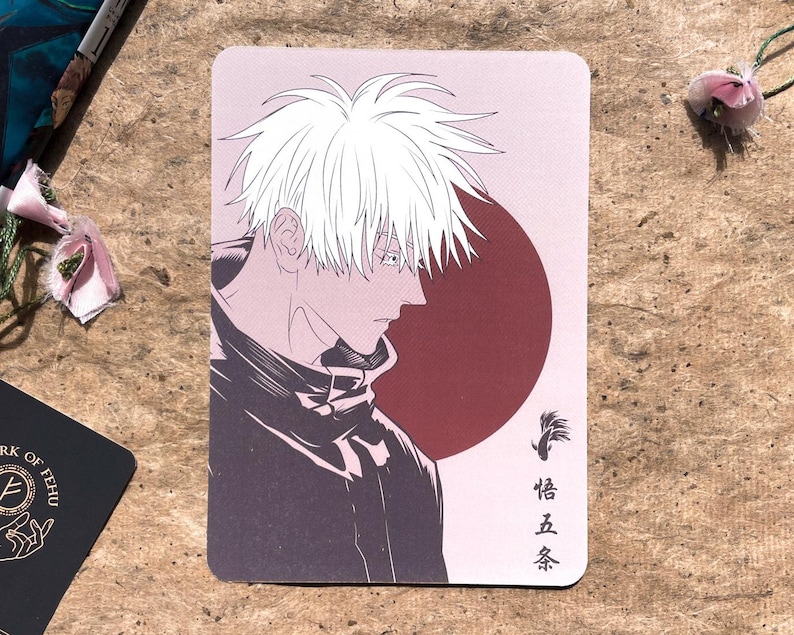May include: A rectangular card featuring an anime-style illustration of a character with white hair and a dark outfit. The background includes a red circle and Japanese text. The artwork is in shades of gray, black, and red.
