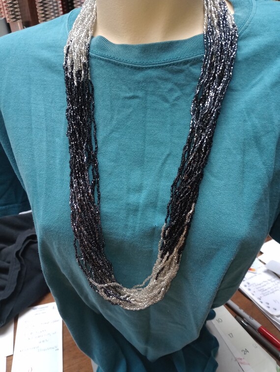 Multiple strands of small beads, silver and black… - image 1