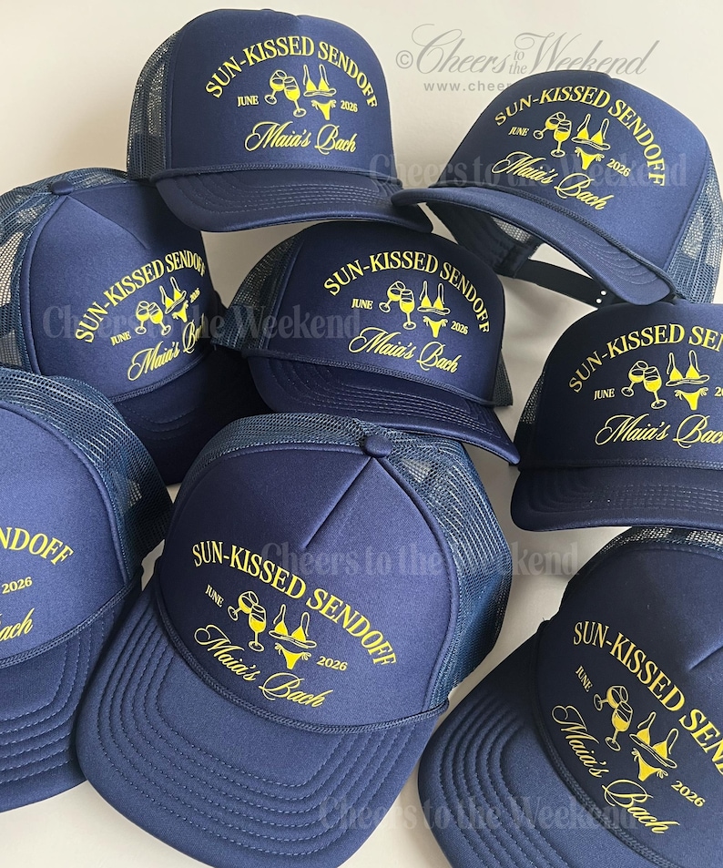 May include: Navy blue trucker hats with yellow text that reads "SUN-KISSED SENDOFF JUNE 2026 Maia's Bach". The hats have a mesh back and a curved brim. The hats are likely for a bachelorette party.