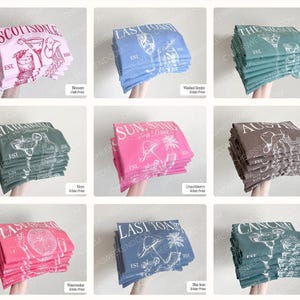 May include: A collection of nine folded t-shirts in various colors including pink, blue, green, and brown. Each stack features a unique graphic print with text such as Scottsdale, Last Toast, Austin, and Cancun, alongside illustrations of cocktails.