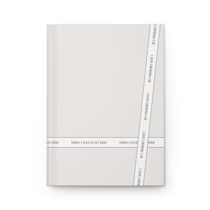 May include: A white notebook with the text "Things I need to get done" and "But probably won't" repeated on the cover.