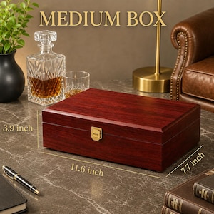 May include: A rectangular wooden box with a dark reddish-brown finish and a gold-colored metal latch. The box is labeled as a MEDIUM BOX and features printed dimensions of 11.6 inches in length, 7.7 inches in width, and 3.9 inches in height.