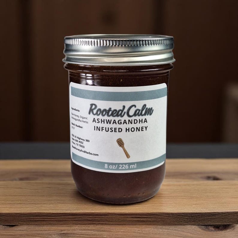 8 oz jar of ashwagandha herbal honey on a wooden surface.
