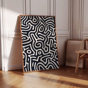 May include: A black and white abstract art print featuring a geometric pattern of lines and curves. The print is framed in a dark wood frame.
