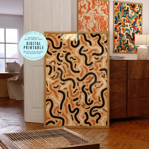 May include: Digital printable wall art featuring an abstract pattern with black, brown, and beige shapes. The design is reminiscent of organic forms and flowing lines. The artwork is framed in a natural wood frame.