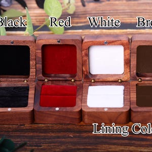 May include: Four wooden ring boxes with different colored velvet linings. The boxes are labeled "Black", "Red", "White", and "Brown". The text "Lining Color" is printed below the boxes.