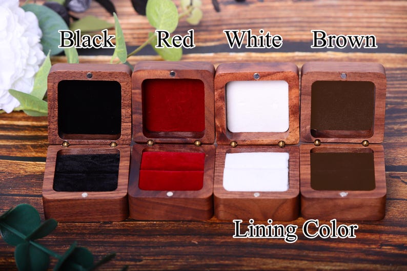 May include: Four wooden ring boxes with different colored velvet linings. The boxes are labeled "Black", "Red", "White", and "Brown". The text "Lining Color" is printed below the boxes.