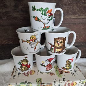 Juego de tazas vintage de Enesco "Suzy's Zoo", 1976, temática invernal, con caja de cartón original.