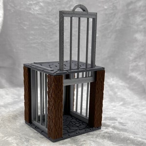 May include: A grey 3D printed cage with a wooden texture on the sides. The cage has a raised platform with a metal railing.