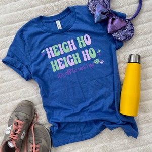 May include: A blue t-shirt with the text "Heigh Ho Heigh Ho it's off to run I go" in pink, green, and white lettering. There are two diamond shapes and stars on the shirt.