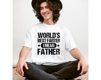 Puede incluir: Camiseta blanca con texto negro que dice "World's Best Farter I Mean Father" con dos estrellas a cada lado de "I Mean".