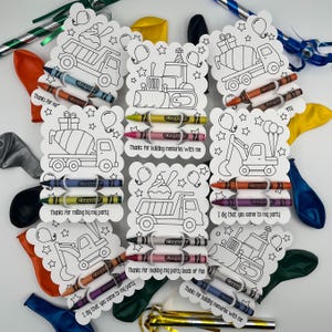May include: A collection of white scalloped cards featuring black line art of construction vehicles, balloons, and stars. Each card includes two Crayola crayons and printed text such as Thanks For building memories with me.
