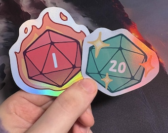 May include: Two holographic stickers of polyhedral dice. One is red with the number 1, surrounded by flames. The other is teal with the number 20 and star accents. Both stickers are held in a hand.