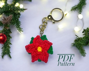 May include: A red crocheted poinsettia flower with green leaves attached to a gold key chain. The text "PDF Pattern" is visible below the flower.