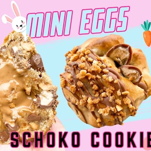 May include: Two chocolate chip cookies with mini chocolate eggs inside. One cookie is broken open to show the chocolate eggs. The cookies are topped with chocolate and chopped nuts. The background is pink and blue with a bunny and carrots.