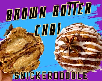 May include: Two halves of a Snickerdoodle pastry with a cream filling, decorated with white icing and star anise. The text "BROWN BUTTER CHAI SNICKERDOODLE" is displayed in a bold, stylized font against a purple and blue background.