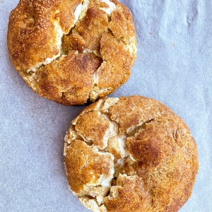 Snickerdoodles cookie, giant vanilla cinnamon cookie with white chocolate chips, and rolled in sugar and cinnamon for crispy crust.