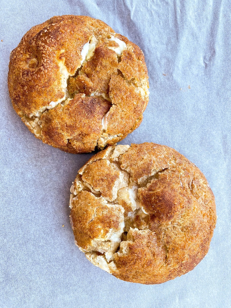 Snickerdoodles cookie, giant vanilla cinnamon cookie with white chocolate chips, and rolled in sugar and cinnamon for crispy crust.