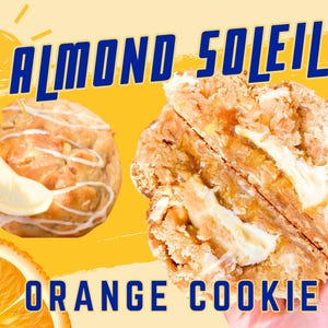 May include: Almond Soleil Orange Cookie, a split cookie with a white filling and a lemon slice on top. The cookie is on a yellow background with a sun graphic and the text "Almond Soleil" in blue.