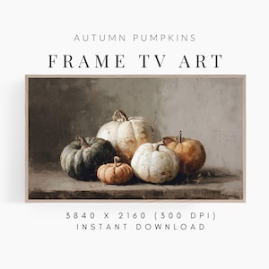 May include: A framed digital artwork featuring a still life of pumpkins. The pumpkins vary in size and color, ranging from white and orange to dark green. The text "AUTUMN PUMPKINS" and "FRAME TV ART" is displayed at the top.