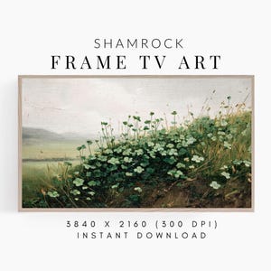 May include: A framed landscape painting featuring a field of green shamrocks and tall grass. The artwork has a vintage aesthetic, with a soft color palette of greens, browns, and whites. The text "SHAMROCK FRAME TV ART" is at the top.