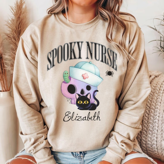 Personalized Name Spooky Nurse Sweater with Black Cat and Skull Nurse, Funny Halloween Sweatshirt, Gift for Pediatric Nurse