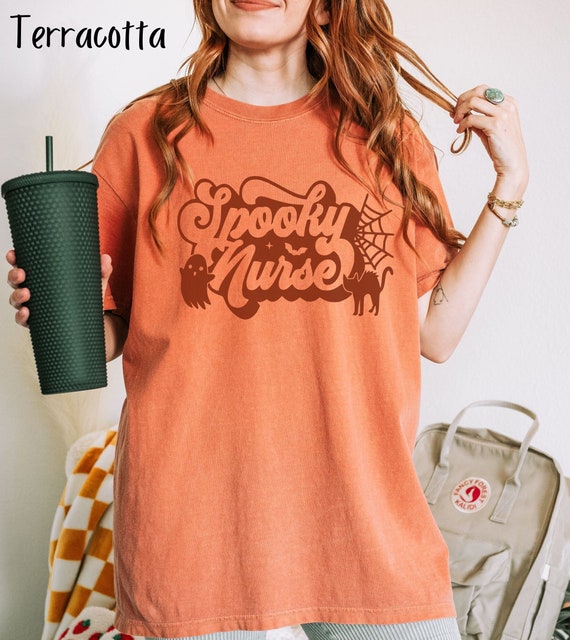 Personalized Nurse Spooky Halloween Oversized Shirt with retro font, black cat, and little ghost, great gift for pediatric, NICU nurses