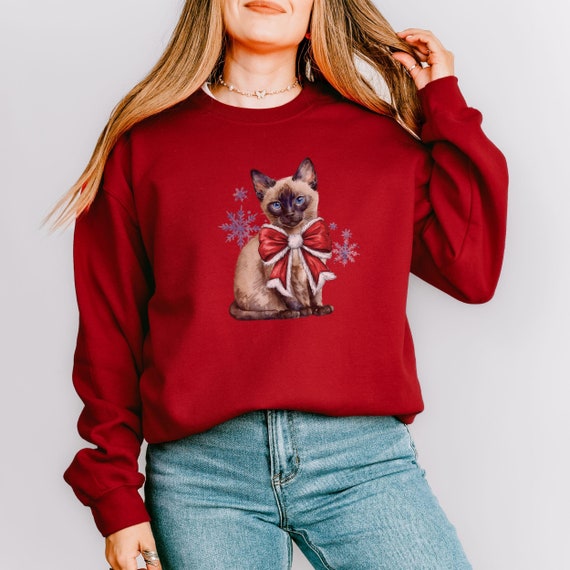 Christmas Coquette Siamese Kitten Crewneck Sweatshirt, Kitty with Red Bow Winter Snowflakes Cat Lover Gift, Festive Pullover for Pet Owner