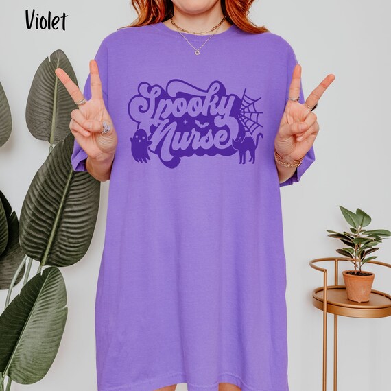Personalized Nurse Spooky Halloween Oversized Shirt with retro font, black cat, and little ghost, great gift for pediatric, NICU nurses