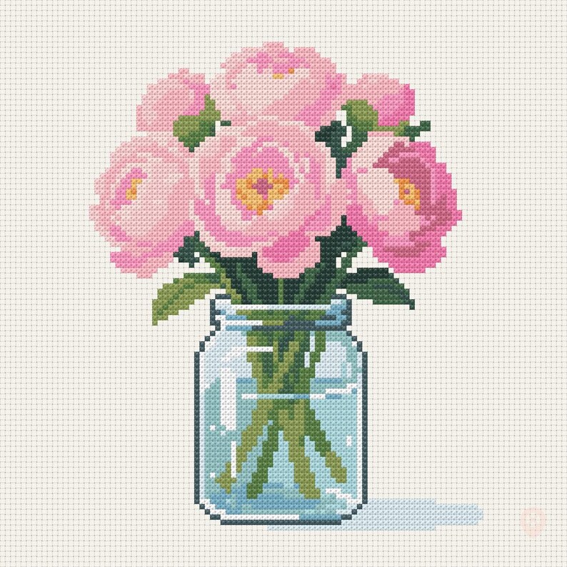 May include: A cross-stitch pattern featuring a bouquet of pink peonies with yellow centers and green leaves arranged in a clear glass mason jar filled with water. The design is rendered on a white grid background with visible pixelated stitches.