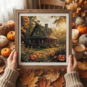 May include: A framed digital art print depicting a rustic cottage surrounded by autumn trees and glowing jack-o'-lanterns. The scene features warm golden sunlight filtering through the foliage, with orange pumpkins scattered across the foreground.