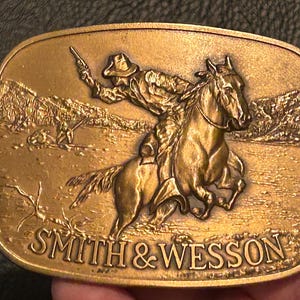 Smith & Wesson, &quot;The Chase&quot; belt buckle, 70s, brass