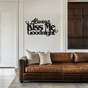 May include: Black metal wall decor with the text "Always Kiss Me Goodnight" and two small hearts.