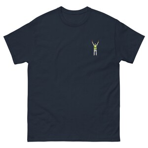 May include: A navy blue t-shirt with a small embroidered image of a person wearing a yellow safety vest and raising their arms in the air.