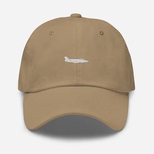 May include: A tan dad hat with a white embroidered silhouette of a jet plane.