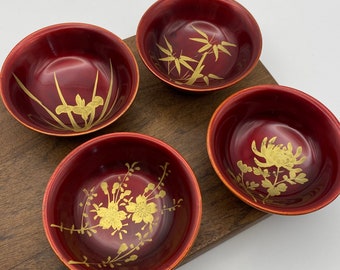 Set of 5 vintage Japanese red shudame-nuri lacquerware. Each has a unique botanical hand-painted in gold. 4 small dishes & 1 large dish.