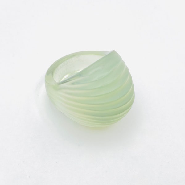 Signed Lalique Narita ring with rippling cabochon shape and shimmering in translucent greens yellows and blue. Original box included. 1990s.