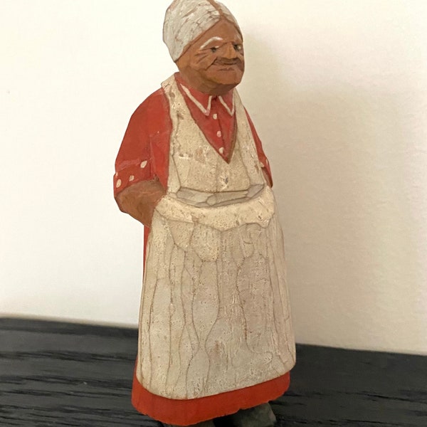 Vintage carved wooden figurine of elderly woman with apron and high bun. Swedish folk art. 1960s.