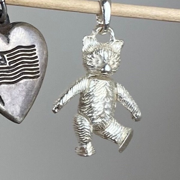 Teddy bear charm for bracelet or necklace in sterling silver with articulating arms, legs, and head.