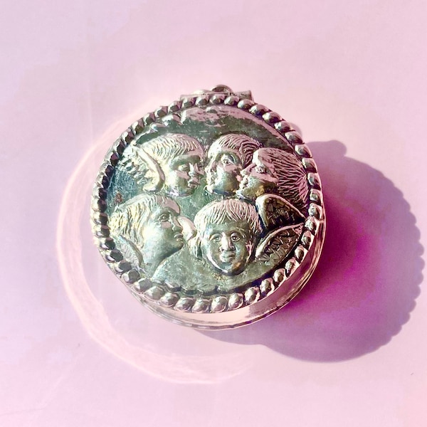 Vintage sterling cherub locket pendant with five angels in repoussé repeated on each side. Possibly Victorian revival.