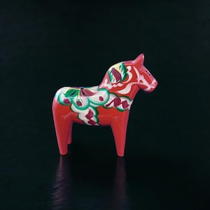 Classic vintage hand-carved Swedish Dala horses in red. This Dalahäst likely date 1970s. She measures 5” x 4.75”. Made in Sweden.